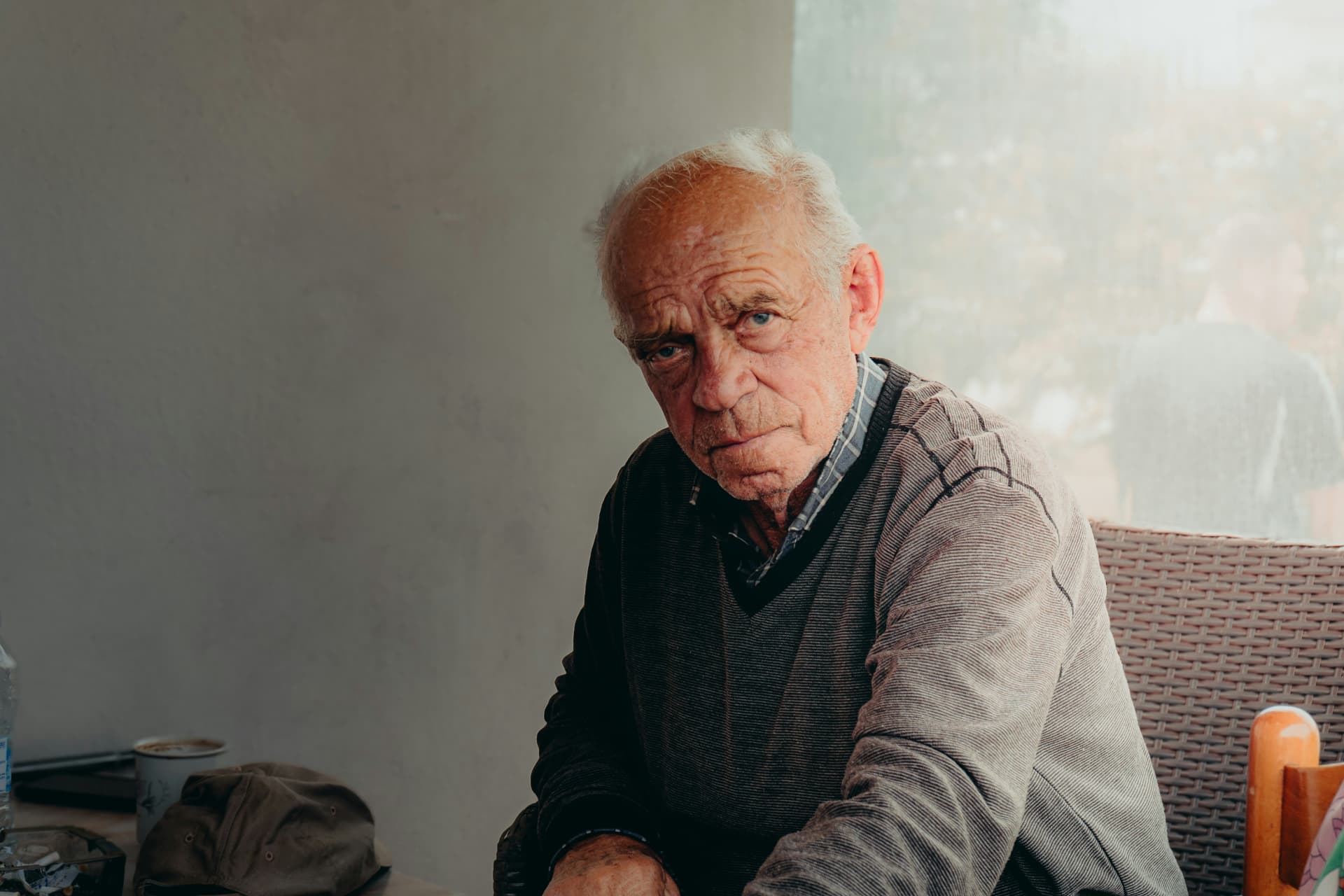 Long-time homeowner seated by a window