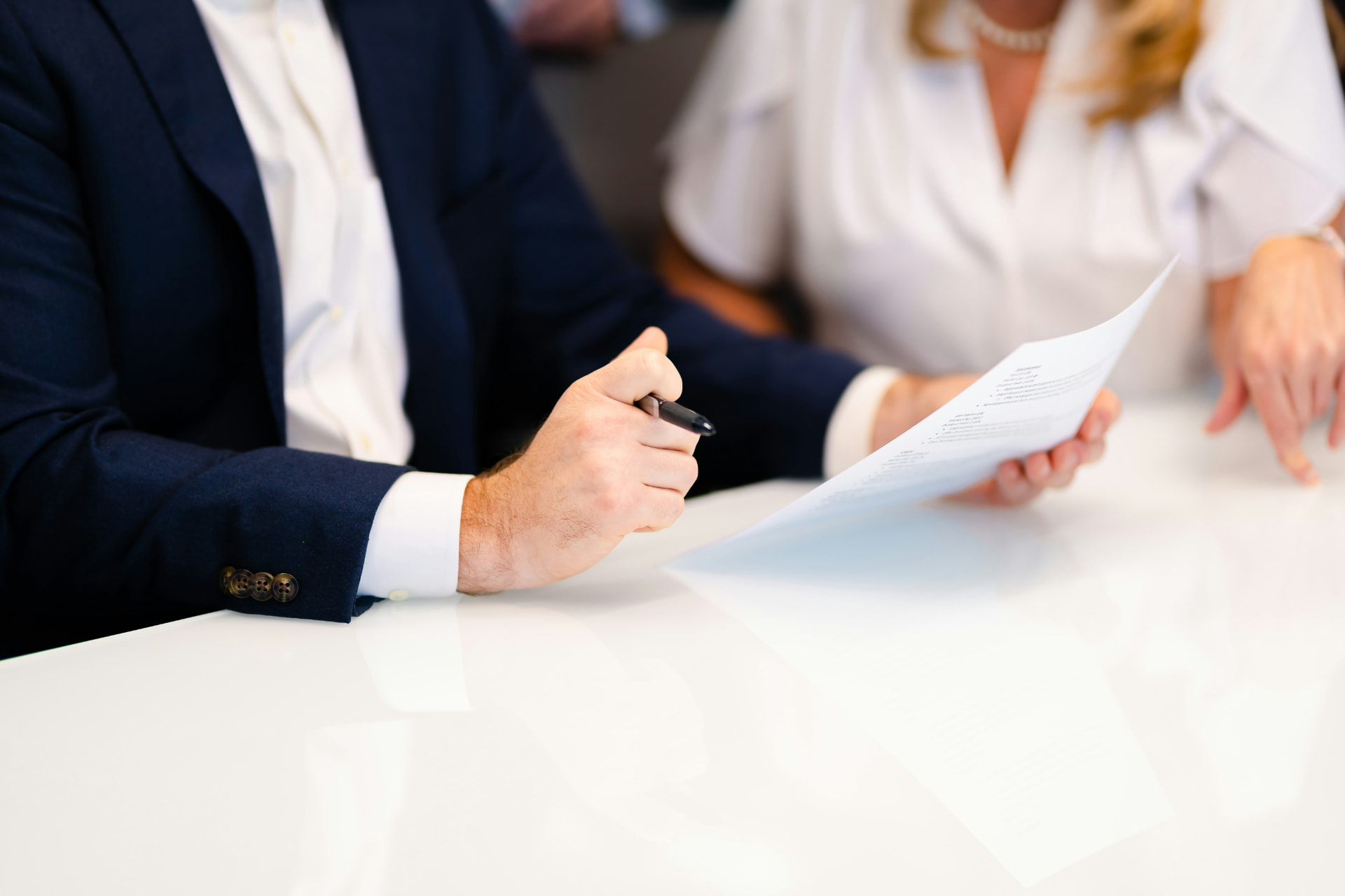 Seller signing closing documents at a title company table