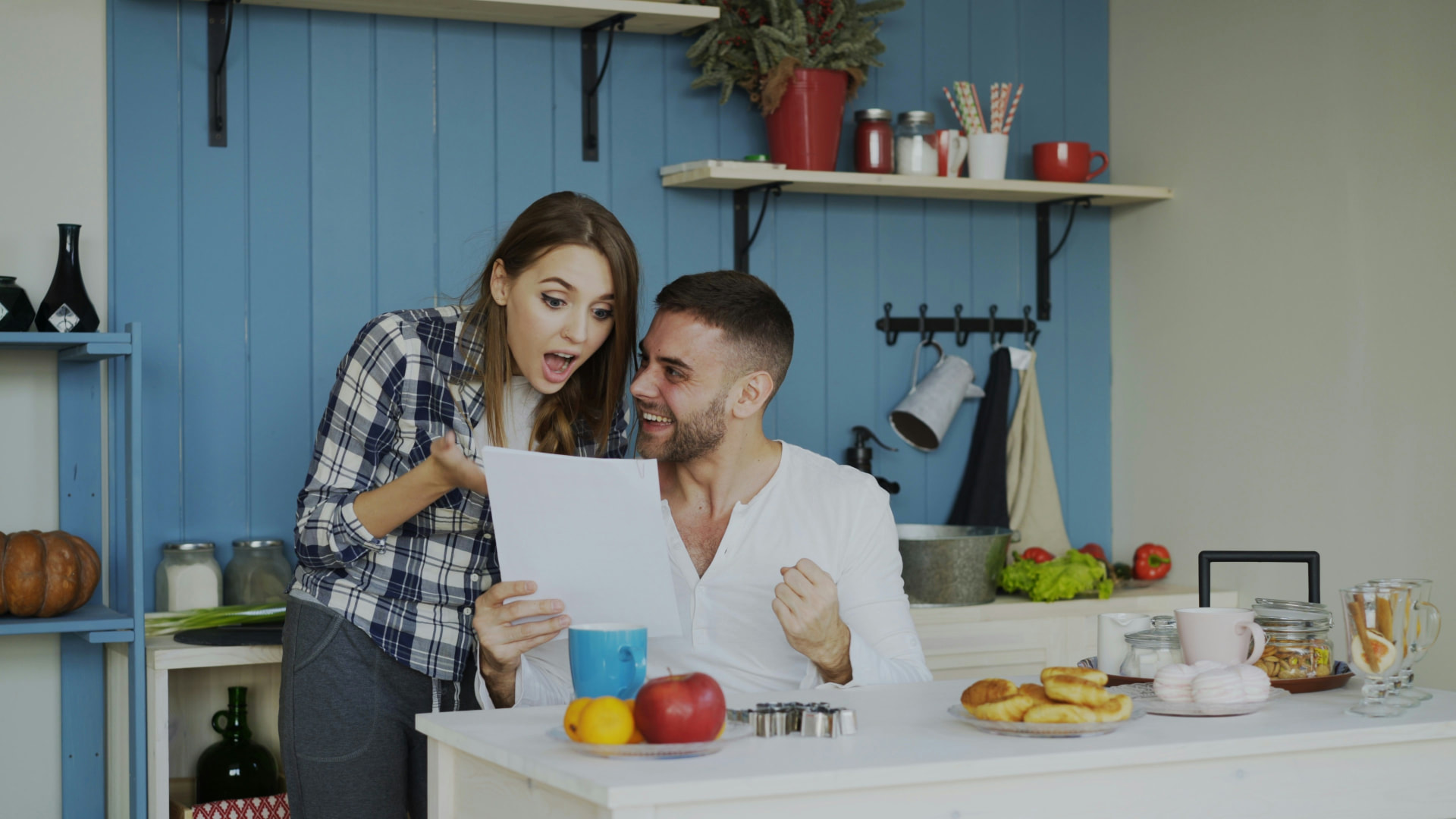 Couple reading their written offer together at the kitchen counter